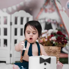 Dressed up and ready for his first taste of cake. This little gentleman is looking sharp for his cake smash session, a fun and memorable way to celebrate turning one.