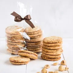 Our Hazelnut Sandwich Cookies, two crisp hazelnut biscuits held together with a creamy chocolate hazelnut filling. They are a nutty and satisfying treat, perfect with a hot drink.