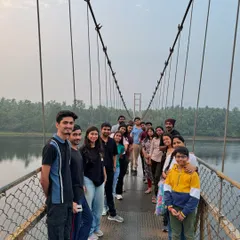 Our group posing on a picturesque suspension bridge over the river during our Gokarna trip, a perfect spot for photos.