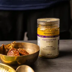 My Curd Chilli Podi, presented alongside the sun-dried curd chillies that give it its distinctive flavour. This mother's blend is the perfect fiery and tangy companion for soft, neutral-tasting idlis and dosas.