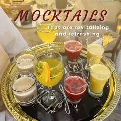 Our mocktails are revitalizing and refreshing. A server presents a tray of colourful drinks, including fresh juices and creamy shakes, offering something for every taste.