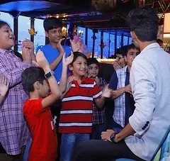 Magic is for everyone! Here I am entertaining a group of kids at a birthday party. Their energy and excitement are contagious, and I have specific routines designed to keep younger audiences amazed and laughing.
