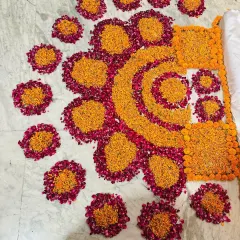This flower rangoli was designed specifically for an Annaprashan ceremony, with spaces created to place the different food items for the baby's first meal.