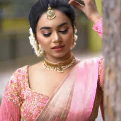 This close-up shows the neatness of the bridal updo, with every strand in place. The hairstyle is designed to be elegant and secure, framing the face beautifully.