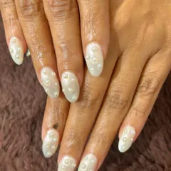 A beautiful and delicate set of pearly white nails with 3D pearl accents scattered like raindrops.