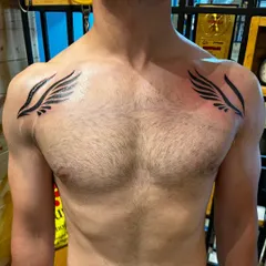 Another view of the chest cover-up tattoo, showing how the wings are placed to create a strong, masculine aesthetic.