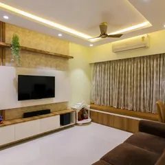 In this living room, we combined a textured wallpaper panel with wooden accents for the TV unit. A built-in seating area by the window provides extra seating and a cozy spot to enjoy the view.