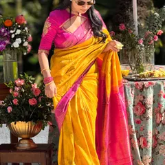 A candid shot of me adjusting my saree. This yellow and pink Kanchivaram is one of my favorites for its vibrant, joyful colors.
