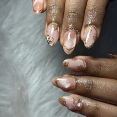 Another angle of this elegant bridal nail art. You can really see the shimmer of the cat eye polish and the intricate gold outlines that match her wedding jewelry.