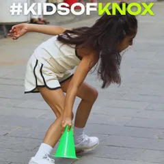 This action shot captures the focus and fun of our outdoor agility drills. Using simple tools like cones, we create challenging courses that improve a child's speed, balance, and ability to change direction quickly.