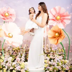 A loving gaze between mother and daughter. This portrait from our Mother's Day mini-session captures the adoration and bond they share, surrounded by oversized pastel flowers.