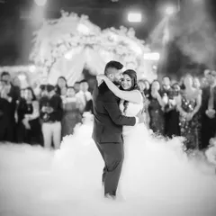 The first dance is pure magic. I capture the energy with dramatic lighting and a focus on the couple's connection, creating a timeless black and white photograph of the celebration.