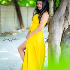 A bright yellow dress against the green foliage. This shot shows how we can use natural elements and props to create a vibrant, story-driven image.