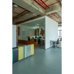 This is the 8-Bit office for the digital agency 22feet. We kept the ceiling exposed with its red pipes and ductwork, and placed glass-walled meeting rooms in the center to maintain an open, industrial feel.