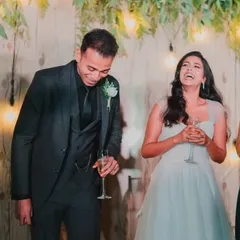 A candid moment of pure laughter shared between the couple during their reception toasts. These are the genuine moments that make the best memories.