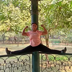 Combining strength and flexibility with this split on a park fence. Holding this pose requires not just flexible legs but also a strong core and upper body to maintain balance.