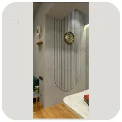A detail of the office wall, featuring vertical grooves carved into concrete texture paint. This technique adds depth and a unique tactile quality to the space.