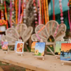 A lineup of the mini paintings I created as wedding favors. Each one is a unique little landscape, from sunny beaches to flower fields.