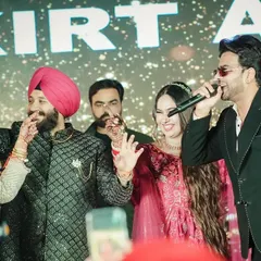 A fun, interactive moment on stage between the couple and performer Mankirt Aulakh.