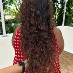 Look at that healthy shine and definition. Proper cutting and coloring techniques are key to keeping curly hair looking its best.