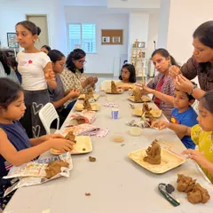 Our instructors provide hands-on help, guiding participants through the steps of molding and shaping their clay Ganeshas.