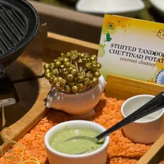 A fusion of North and South Indian flavors. These are Stuffed Tandoori Chettinad Potatoes, served with a cooling coconut chutney and decorative skewers.