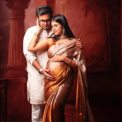 The warmth and intimacy of a couple's bond shines through in this traditional maternity photoshoot. The way they look at each other tells a beautiful story of love.