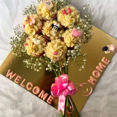 Say it with sweetness with our edible cupcake bouquet. This unique arrangement features beautifully frosted cupcakes presented as a floral bouquet, complete with a "Welcome Home" message, making it a delightful and memorable gift for any celebration.