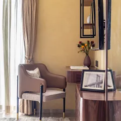 This bedroom corner is transformed into a functional and stylish workspace. A floating wooden desk, an elegant chair, and industrial-style shelving provide a dedicated area to learn, grow, and thrive.