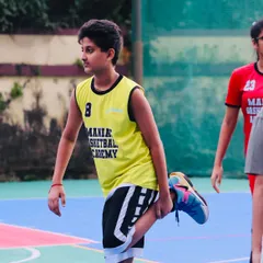 A player stretches during a training session. We teach the importance of preparation and recovery to build sustainable athletes.