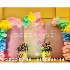 For a modern and chic baby shower, we created this pastel-themed backdrop. It features elegant arched panels with a watercolour finish, an "Oh Baby" sign, and organic balloon arches in a soft, playful colour palette.