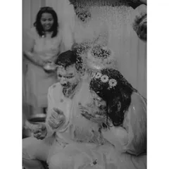 I love capturing moments in classic black and white, even during a colorful Haldi. It strips away distractions and focuses purely on the emotion and action, like this shot of the couple being doused in water.