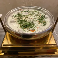 A close-up of our Dahi Vada, garnished with fresh coriander and red chili powder for a Jain event.