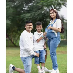 Here’s a creative way to involve older siblings. The big brother plays 'doctor' with a stethoscope on the baby bump, making for a fun and heartwarming family portrait that everyone will cherish.