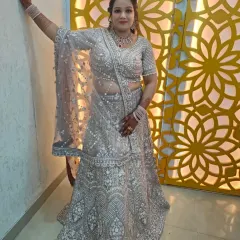This heavily embroidered silver-grey lehenga is a stunning choice for a reception or engagement. The intricate threadwork and pearl detailing offer a modern yet regal feel.