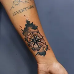 This client had an old "Adventure" tattoo that they wanted to incorporate into a new piece. We designed this compass and map tattoo to cover the old work and give it a new story.