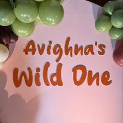 The custom 'Avighna's Wild One' sign for a first birthday party. We create personalized signage that perfectly matches the font and color scheme of your chosen theme.