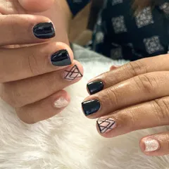 Black nails are always in fashion. This design shows how black can be used on short nails for a sophisticated look, with geometric and glitter accent nails to add a modern touch.