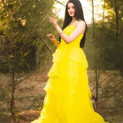 The movement and light texture of the yellow tulle gown are captured in this shot. It's an excellent rental option for creating a fresh and vibrant look for a portfolio.