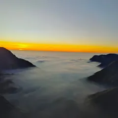 The golden hour in Munnar. The sun rising over the valley filled with clouds is a sight you will never forget.