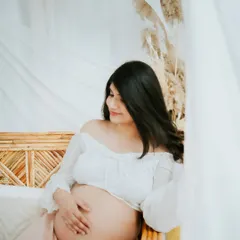 Embracing the serene and dreamy side of motherhood. This studio session uses soft lighting and flowing fabrics to create a calm, beautiful portrait that focuses on the peaceful anticipation of meeting your little one.