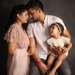 **Timeless Dark:** This intimate family portrait shows how a dark background can create a moody, emotional, and deeply connected feel.