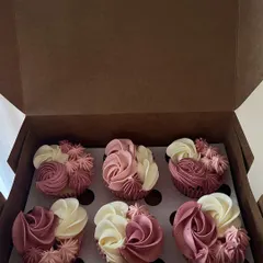 A box of six cupcakes with two-toned floral buttercream piping. This style is perfect for adding a touch of elegance to any occasion, offering a beautiful alternative to a full-sized cake.
