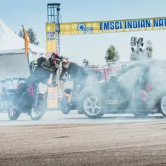 Chaos on the track as stunt riders and a drift car create a symphony of smoke and skill. This is the kind of organized mayhem that our fans love.