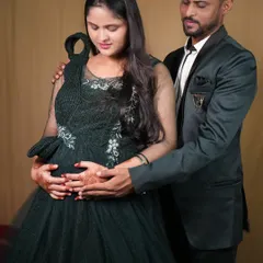 An intimate pose for a couple's maternity photo. The dad-to-be gently holds the baby bump, creating a photo full of love and anticipation.