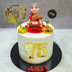 A truly special cake to celebrate 75 graceful years. I created a custom figurine of the 'Aaji' (grandmother) reading her holy books, surrounded by edible prasad and puja items, making it a deeply personal and respectful tribute.