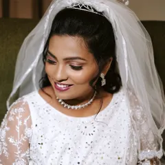 A close-up of my Christian bride's makeup. I used soft, shimmery eyeshadow and a berry-toned lip to enhance her features while maintaining a classic and elegant feel.