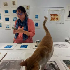 A candid moment from one of our bustling print sales, complete with our resident cat and quality inspector, Julie. These events are the heart of our community, helping us fund new projects and make art accessible to everyone.