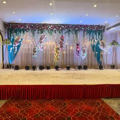 Another stunning stage design at Sky banquet hall, featuring hanging floral arrangements and a colorful backdrop. This setup is perfect for a vibrant sangeet or reception.