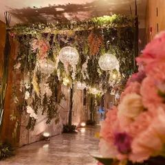 An entryway designed to feel like a hidden, enchanted garden. I used cascading ferns, ivy, and white orchids, interspersed with glowing crystal balls, to create a mysterious and magical passage.